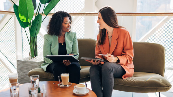 female colleagues are talking casually during a coffee break in a modern office