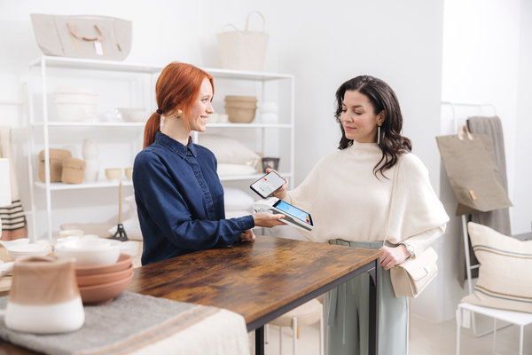 Woman paying using DCC service